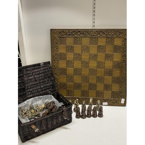 60A - A large chess board with statue form pieces shipping unavailable