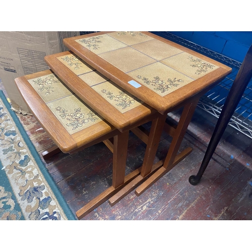 65 - A nest of three mid century teak tables with tile inserts, 53x39cm  shipping unavailable