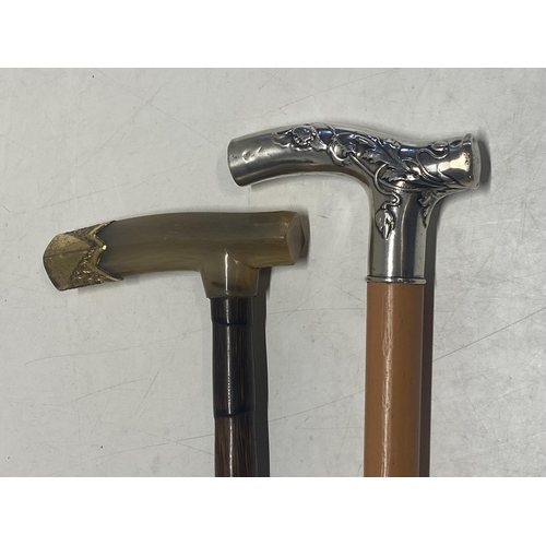 307 - Two vintage walking canes one with horn and gilt metal handle and the other with a hallmarked silver... 