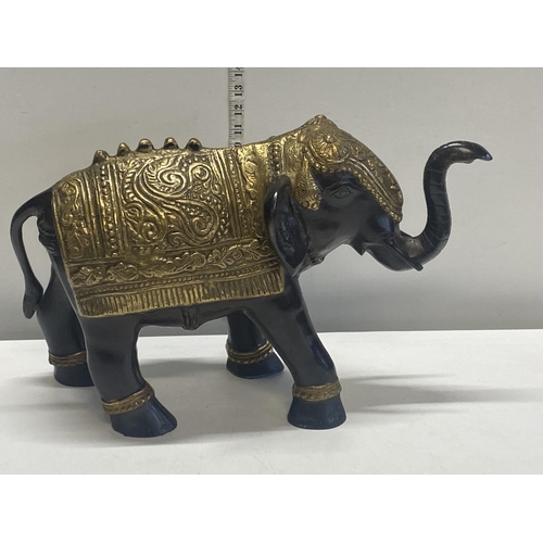 308 - A very heavy bronze hollow cast Oriental elephant with gilt decoration weighs 11kg 35x52cm