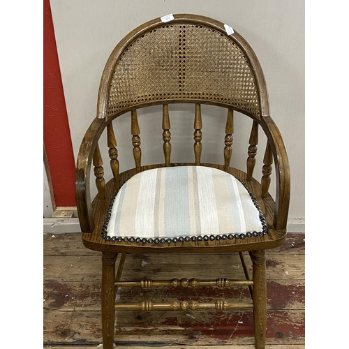 358 - A quality oak handmade chair by Andy Thornton with cane back support and padded seat