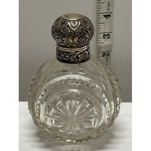 114 - A hallmarked silver topped glass scent bottle with stopper