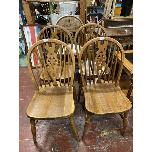 357 - Four vintage wheelback chairs Shipping unavailable.