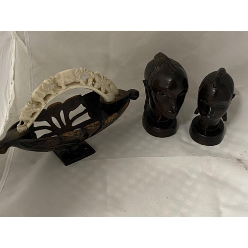 42 - Two carved wooden African busts and a small wooden basket