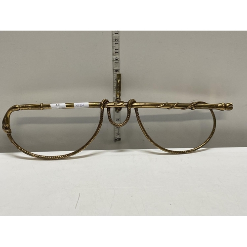 45 - A unusual heavy brass wall mounted hanging rack in the form of a riding crop