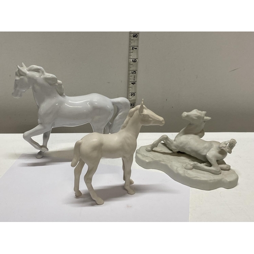 64 - A selection of white ceramic horses including Royal Doulton