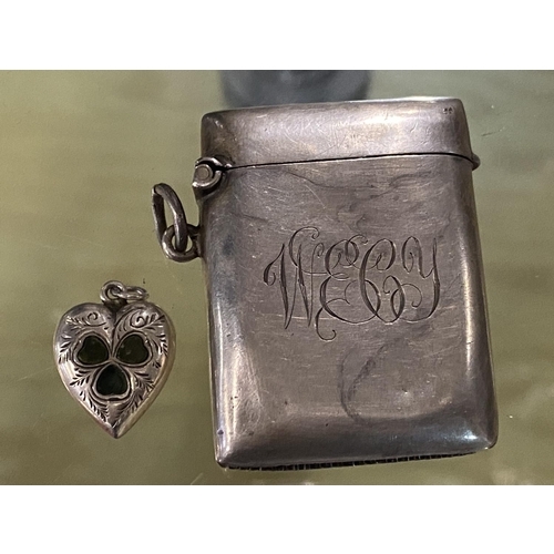 122 - A hallmarked silver vesta case and small heart locket