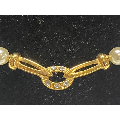 332 - A string of simulated pearls with 14ct gold fittings