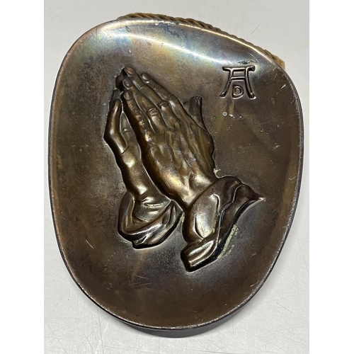 321 - A small After Albrecht Durer bronze plaque with praying hands, signed