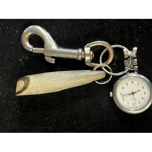 322 - A unusual carved horn whistle and a matrons watch