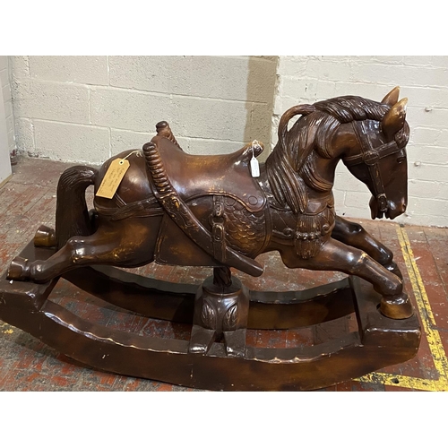 335 - A large antique Chinese rosewood rocking horse. 94cm tall x 130cm long. shipping unavailable