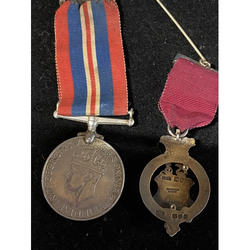 286 - A silver masonic medal and a WW2 medal