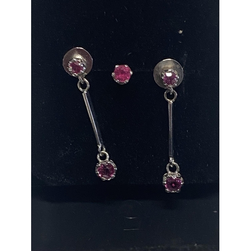 146 - A commissioned pair of 9ct white gold & ruby earrings with additional stud not hallmarked