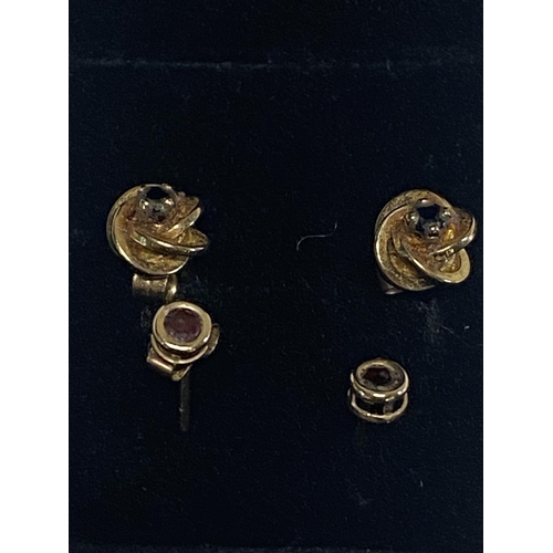 151 - Two pairs of 9ct gold & ruby earrings & gold & sapphire earrings.