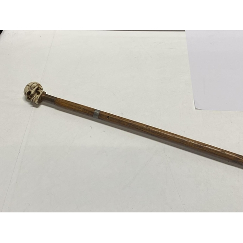 212 - A long walking cane with skull finial 112cm long.  shipping unavailable