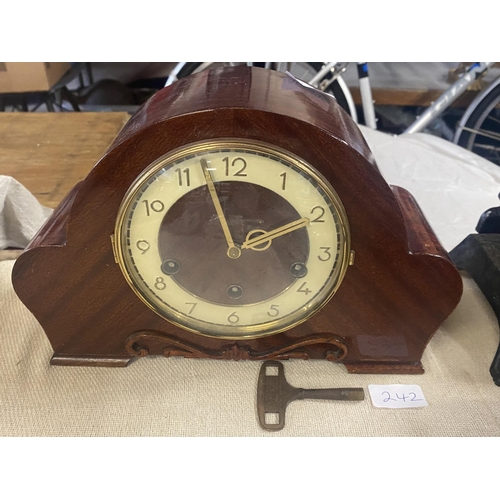 242 - A 1930's wooden cased mantle clock with key & pendulum.