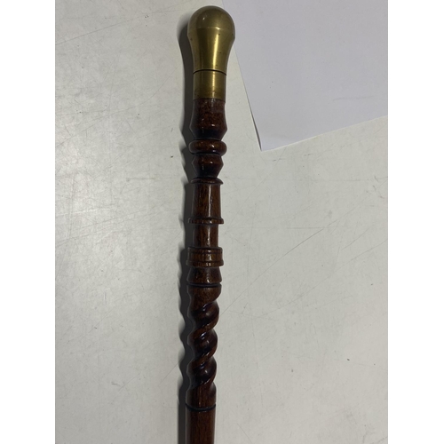 267 - An unusual turned wooden walking cane with brass fittings.  shipping unavailable