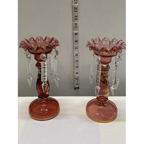 280 - Two early 20th century cranberry glass lustres. (one missing drop) 23cm tall.