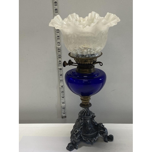 286 - A nice quality Victorian oil lamp with a blue glass reservoir and milk glass shade. 43cm tall.  ship... 