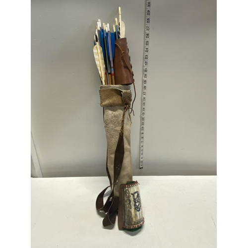 41 - A selection of hand made Native American Indian style arrows two arm protectors  together in a hand ... 