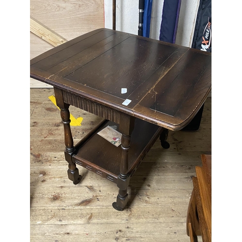 95 - A antique drop leaf table on castors with shelf under. 68cm x 44cm closed size. No shipping.