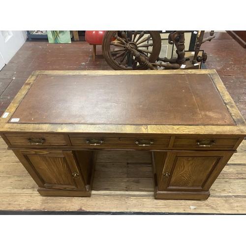 427 - A good quality vintage desk on two pedestals. With three draws & two under cupboards. 122cm x 57cm x... 