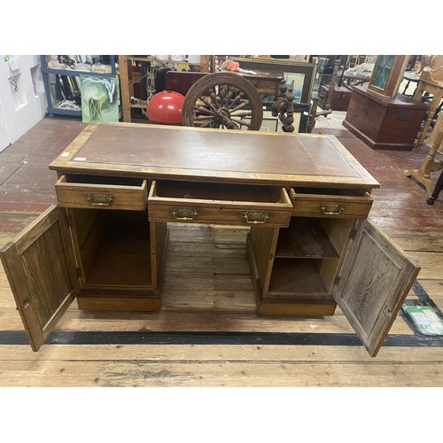 427 - A good quality vintage desk on two pedestals. With three draws & two under cupboards. 122cm x 57cm x... 