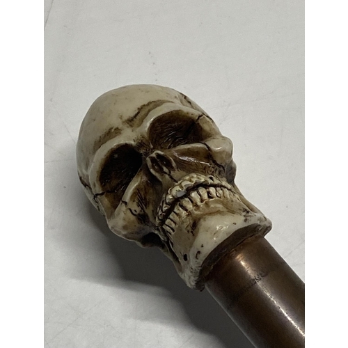 212 - A long walking cane with skull finial 112cm long.  shipping unavailable