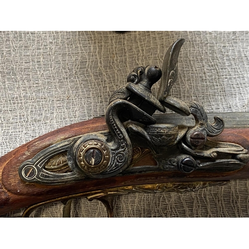 26 - A vintage reproduction wall hanging flintlock musket, shipping unavailable