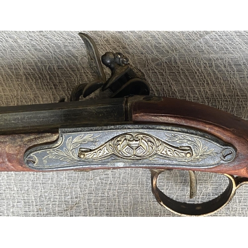 26 - A vintage reproduction wall hanging flintlock musket, shipping unavailable