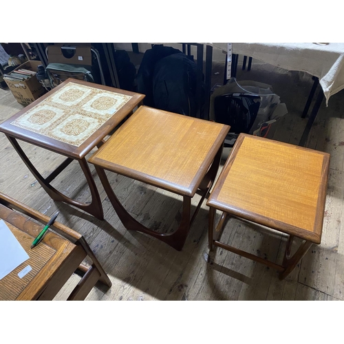 53 - A set of three mid century nesting tables, the largest has a tiled top. shipping unavailable