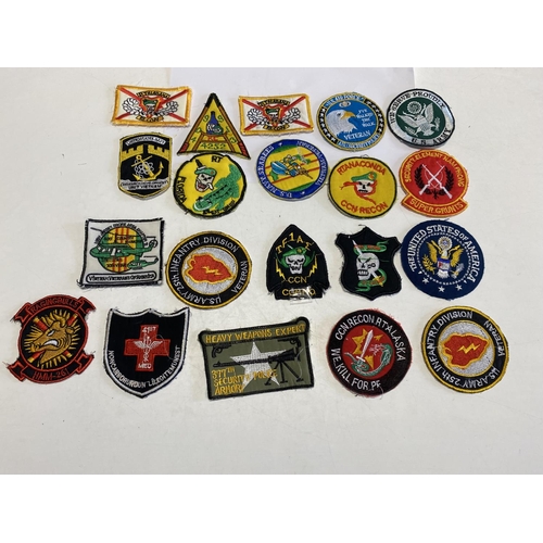 117 - A job lot of Vietnam war period reproduction American cloth patches.