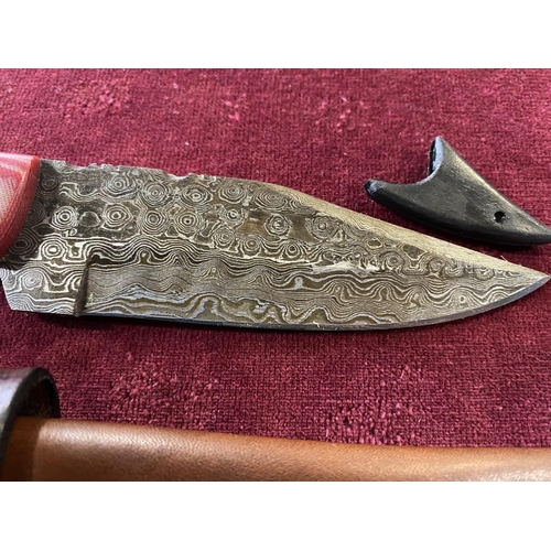 120 - A hand forged Damascus steel bladed knife in leather sheath, over 18's only, UK post only