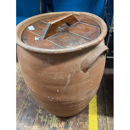 118 - A terracotta lidded urn H54cm.Shipping unavailable