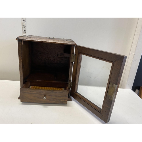 57 - A vintage smokers cabinet with key.Shipping unavailable