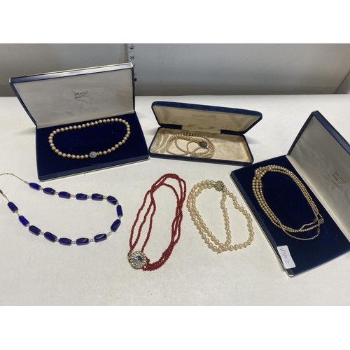 200 - A selection of costume jewellery necklaces, one with silver clasp