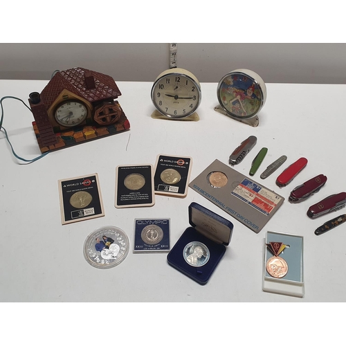 236 - A job lot of assorted collectables including alarm clocks, pen knives and coins etc, shipping unavai... 