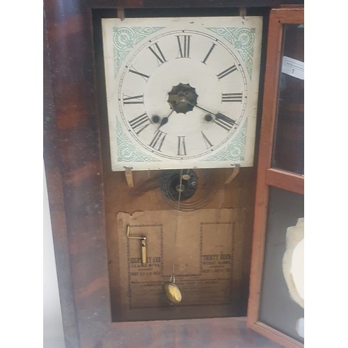 203 - A antique American Ansonia wall clock with key and pendulum, (untested) 66x40cm shipping unavailable