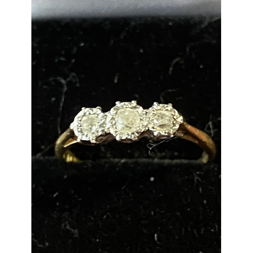 136 - A 18ct gold and three stone diamond ring total weight 2.48g