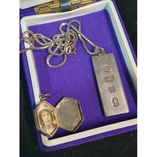130 - A hallmarked silver locket and a 1oz silver ingot with a 925 chain