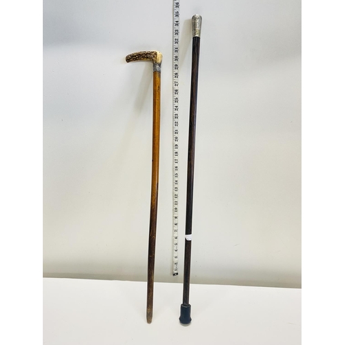 144 - A silver topped walking cane and one other  shipping unavailable.