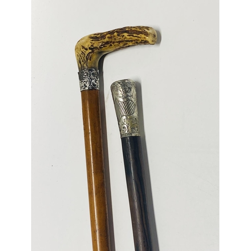 144 - A silver topped walking cane and one other  shipping unavailable.