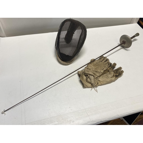 311 - A antique fencing set including wire face guard mask with affixed leather sabre neck bib, white leat... 