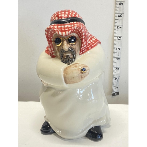 145 - A unusual Arabian pottery figure.