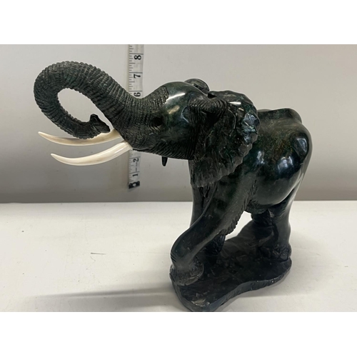 278 - A heavy hand carved elephant carved from one piece of malachite.