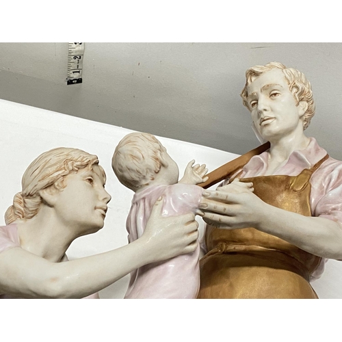2 - A large Royal Dux figural group model number 11559 'The Blacksmith Family' (crack to rear of base, p... 