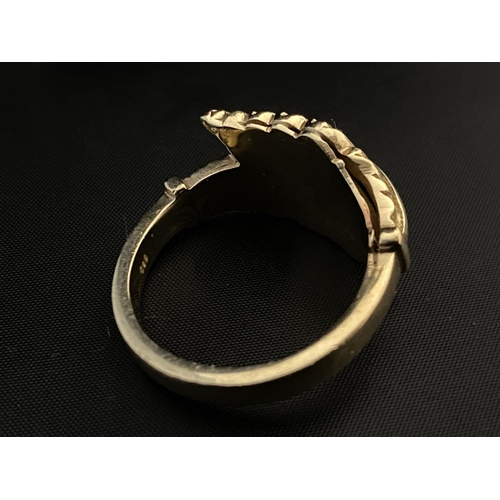 147 - A large heavy tests for 14ct gold gold ring with fern leaf design. Size X 14.25 grams.