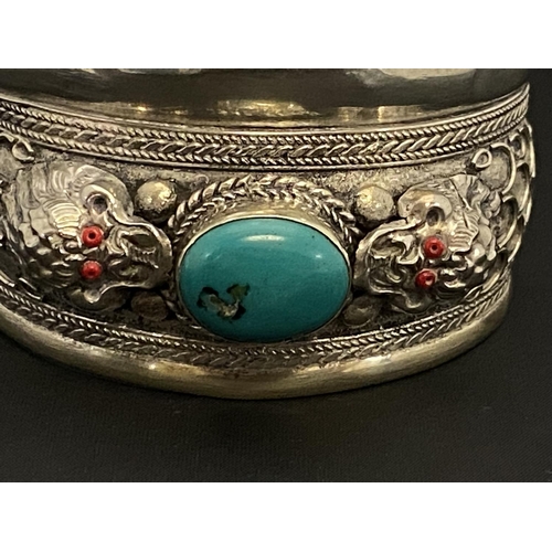 114 - A white metal cuff bracelet with turquoise and dragon decoration a/f