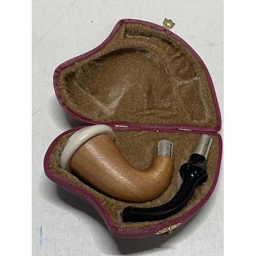 28 - A cased smokers pipe with silver collars