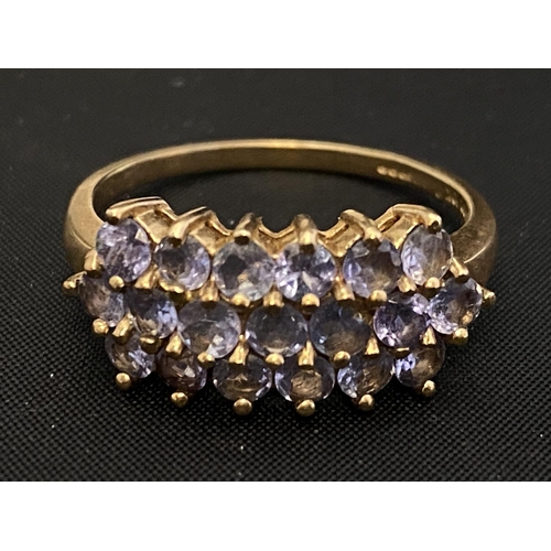 156B - A 9ct gold ring set with three rows of amethysts size V1/2 4.12g